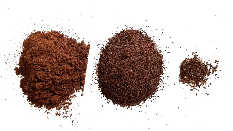 Three piles of coffee grounds from fine to coarse from the KINGrinder K2