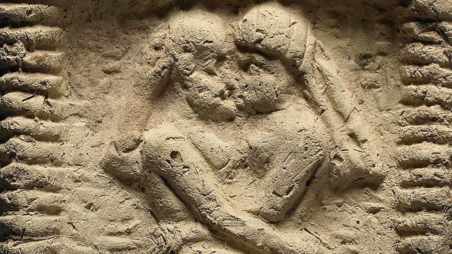 A clay model from Mesopotamia dating to 1800 BC shows a nude couple intertwined on a bed, engaged in sex and kissing.