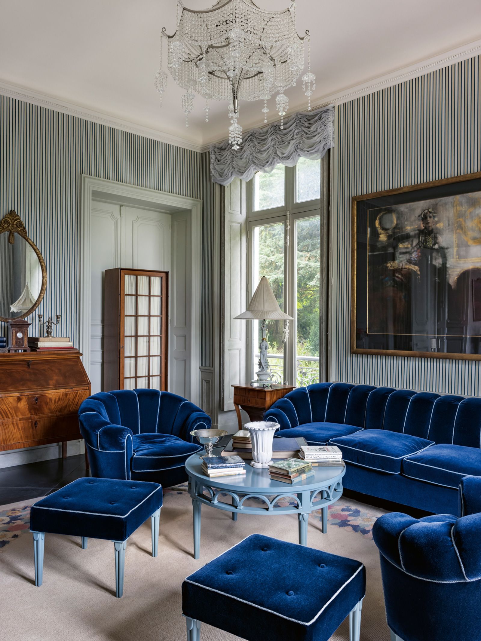 Throughout Villa Louveciennes, Lagerfeld took inspiration from his previous residences — what Kalt describes as "a compendium of his previous passions." Pictured above, a living space outfitted in lush blue velvets.