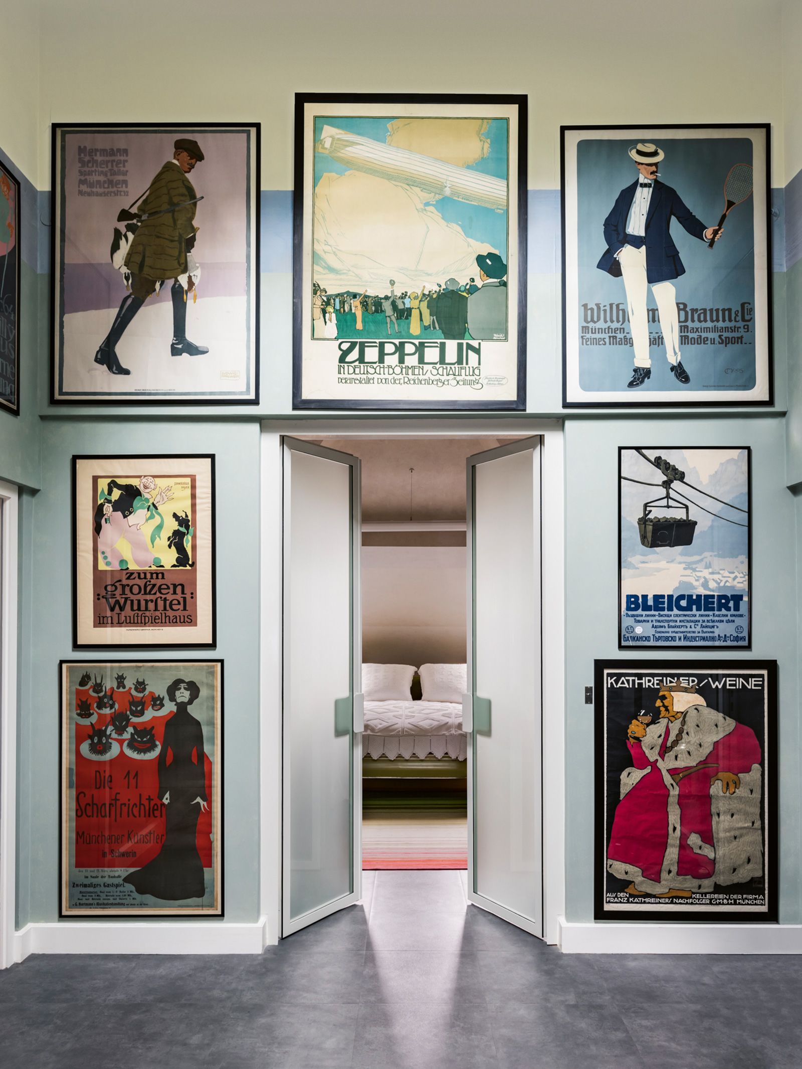 A series of German advertising posters (which Lagerfeld collected) from the 1910s and 1920s are presented collage-style on the walls outside a bedroom at Villa Louveciennes.