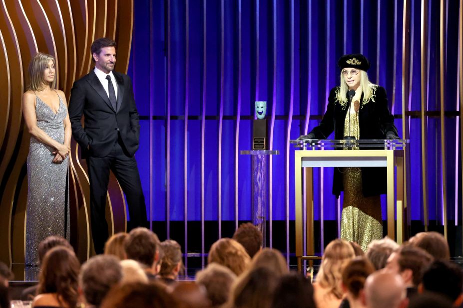 Presenters Jennifer Aniston and Bradley Cooper look on as <a href="https://www.cnn.com/2024/02/24/entertainment/jennifer-aniston-barbra-streisand-sag-awards-2024/index.html?iid=cnn_buildContentRecirc_end_recirc">Streisand accepts the life achievement award</a> at the 2024 Screen Actors Guild Awards in Los Angeles.