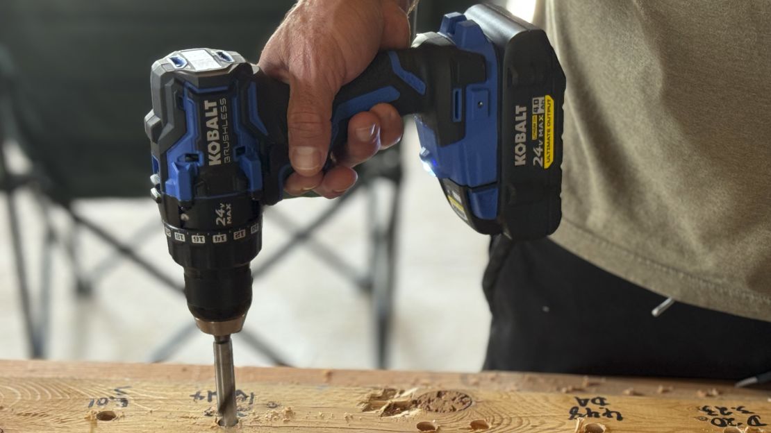 Kobalt drill, drilling a hole into a piece of wood.