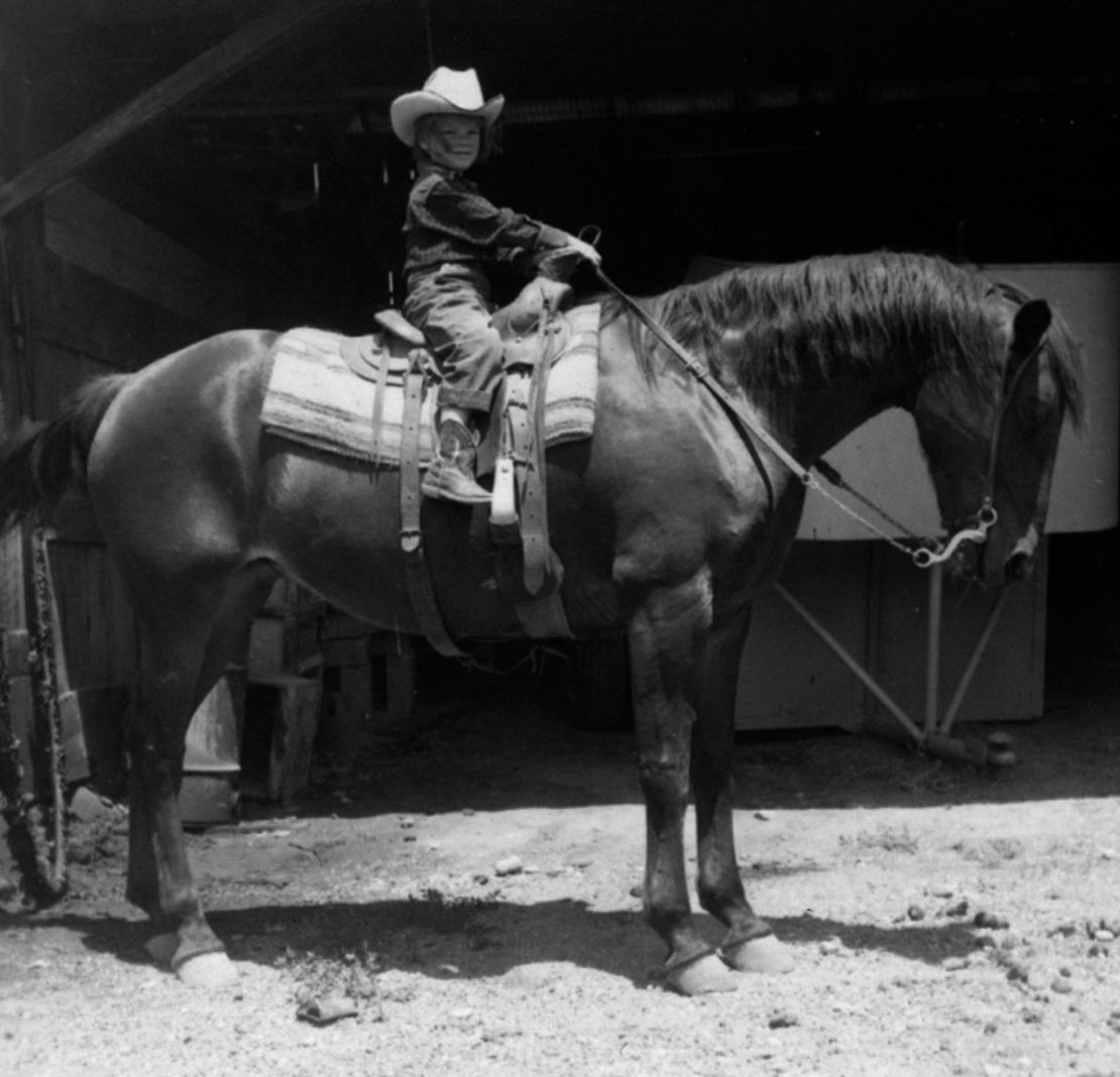 Kris Tompkins as a child, pictured atop a horse, 1958.