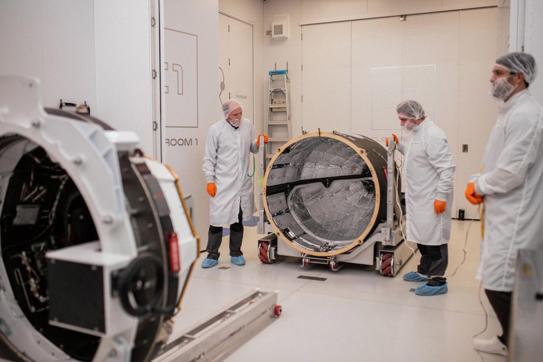 Technicians integrate PREFIRE inside the Rocket Lab Electron rocket payload fairing on Wednesday at the company’s facility in New Zealand.