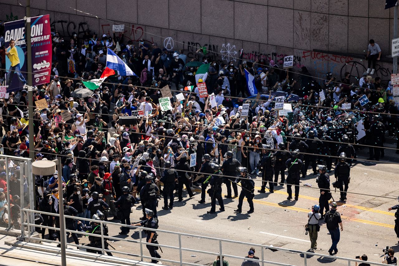 Agentes del orden se enfrentan con manifestantes frente al edificio federal durante una protesta tras los operativos federales de inmigración en Los Ángeles, California, el domingo.