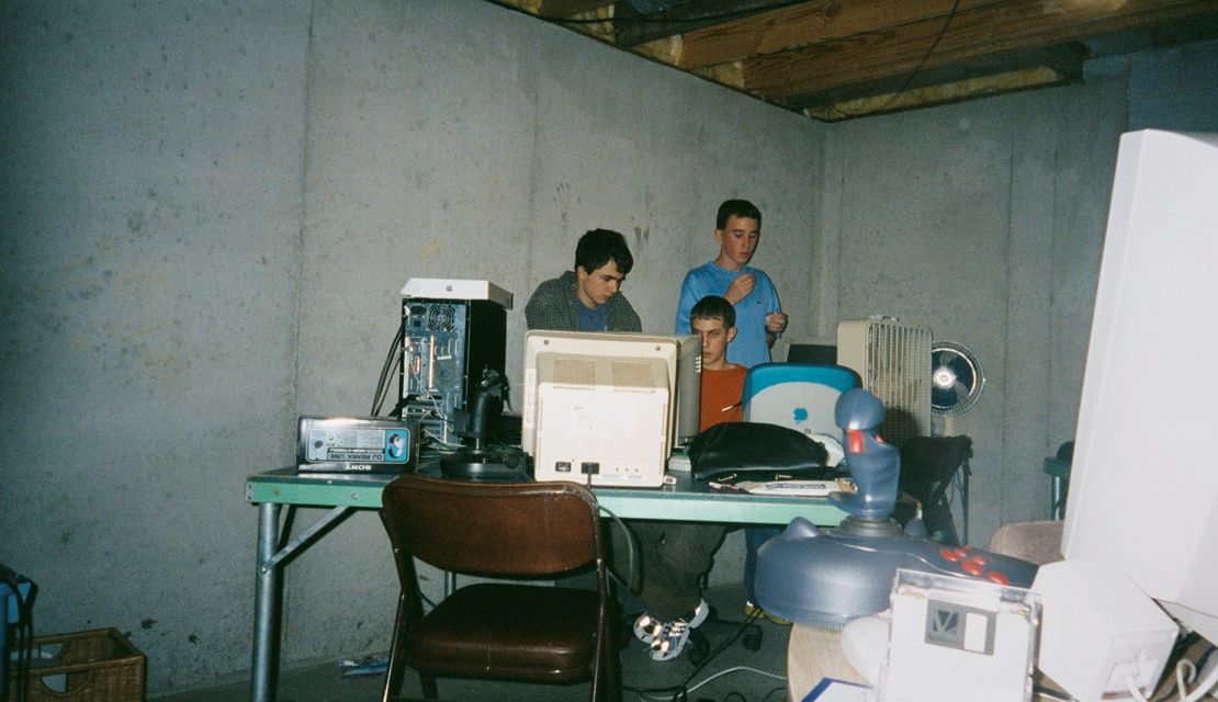 Many of the visuals in "LAN Party" are also an artifact of the wider trends happening at that point in time. Posters of hip-hop artist, 90s pin-ups and anime series, bubble furniture and baggy jeans can be spotted in the periphery. Or not, in the case of the sparse photo above, of gaming fans — and indoor fans — in Lee's Summit, Missouri in 2001.