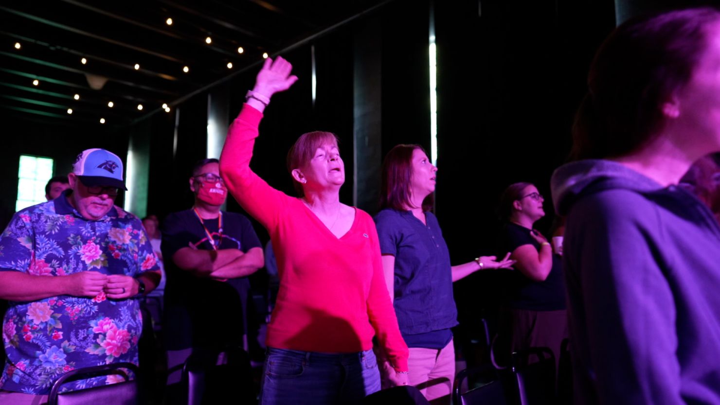 Larissa Miller, right, and her partner worship during a service at Watershed.