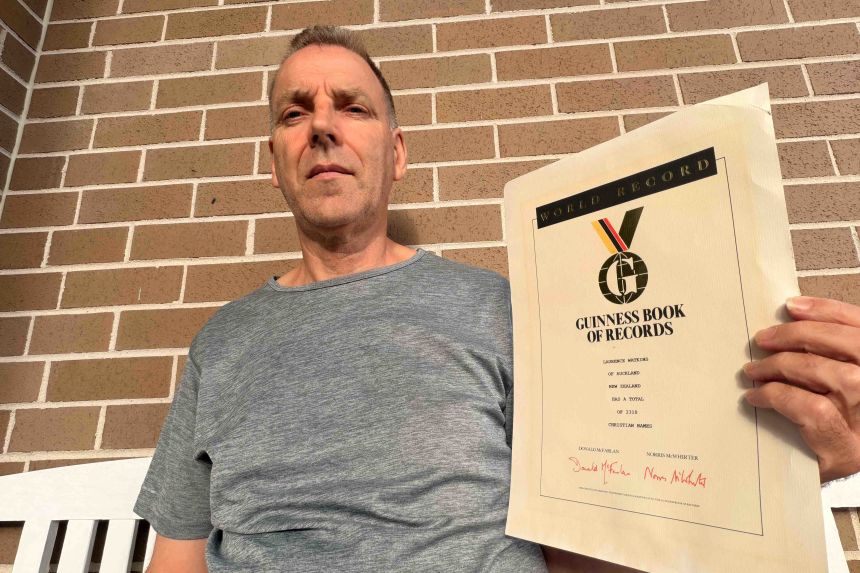 Watkins poses with his covered Guinness World Record certificate.