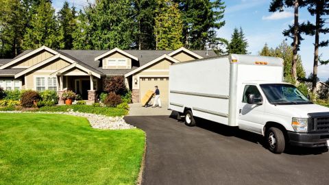 Mover unloading boxes from a moving van