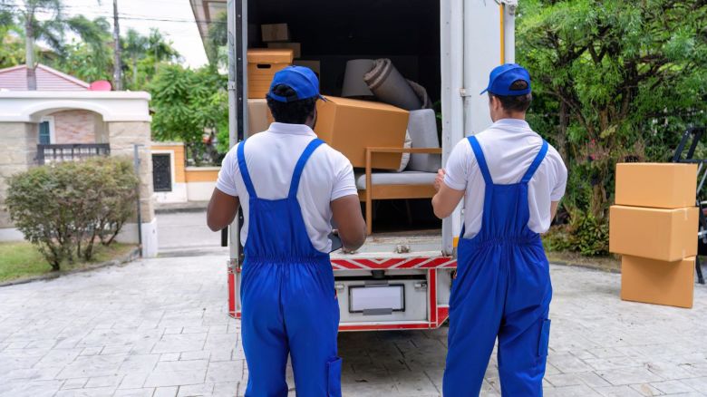 Two movers taking stock of the items they have put into the moving truck