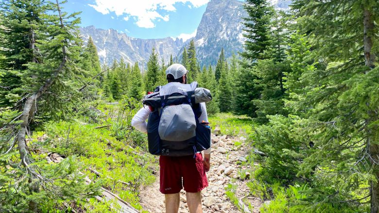 Man backpacking with a view of the mountains