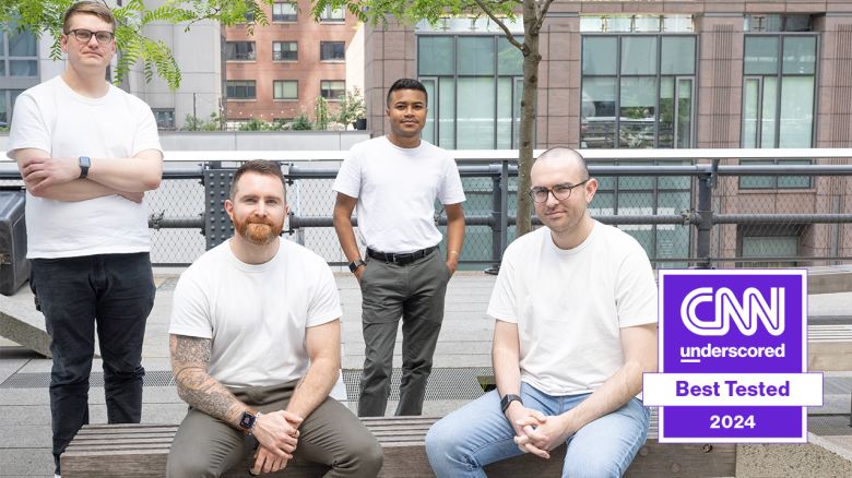 Four CNN Underscored editors pose for a photo while wearing some of the best white T-shirts for men.