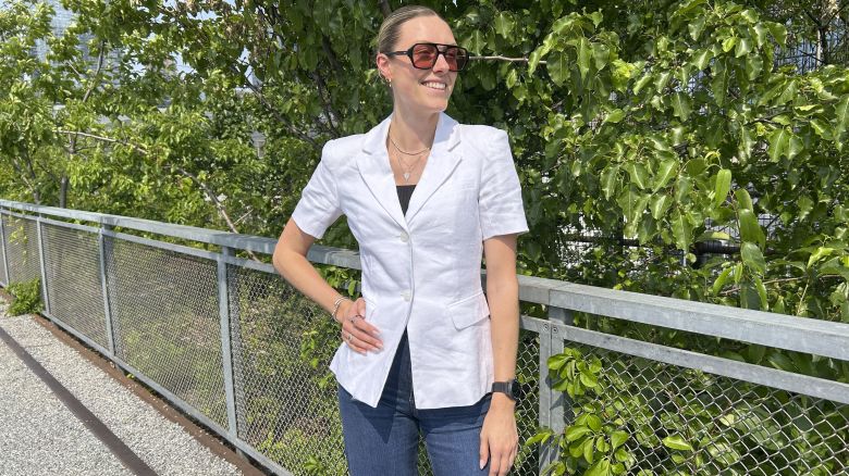 ellen wearing white linen short sleeve blazer in front of trees