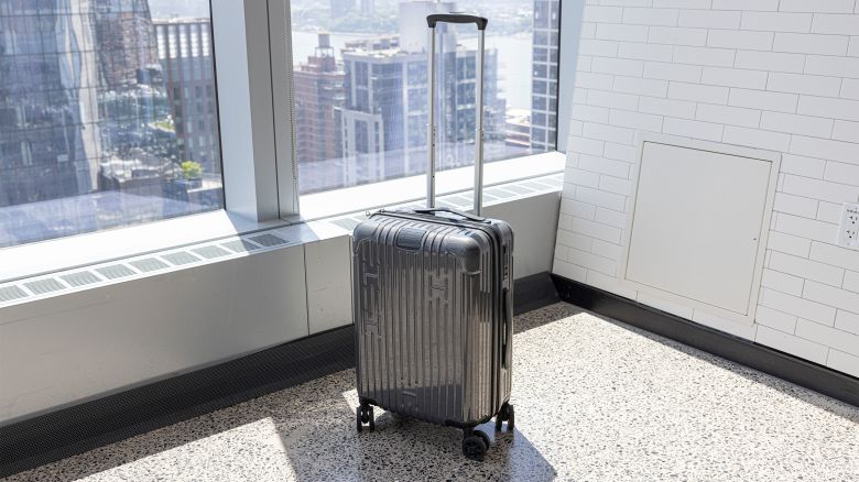 A photo of the Hotel Collection Carry-On bag in front of a window in an urban office building