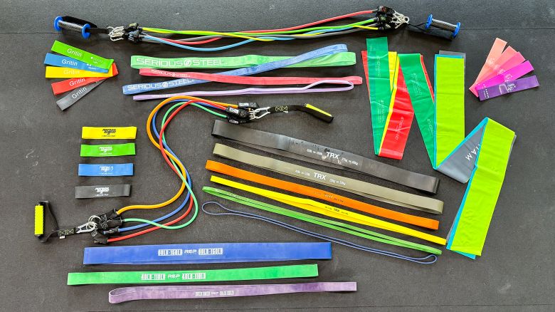 A collection of neon-colored resistance bands on a dark surface.