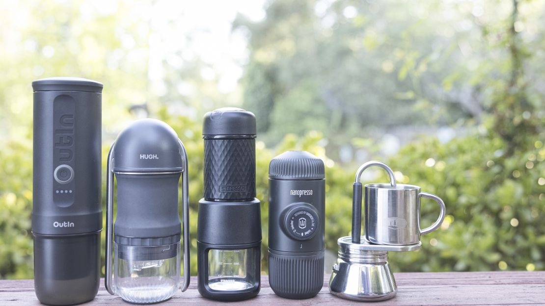 Five portable espresso machines lined up in descending height order.