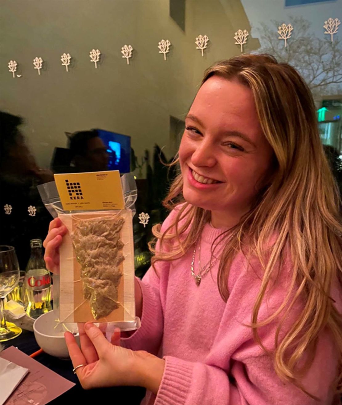 CNN's Leah Collins holds a sample of the Kera chicken-feather protein product at the tasting event in London on April 4, 2024.