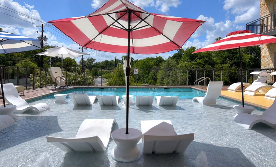 White Ledge Lounger Signature chairs partly submerged in a pool