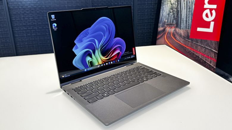 Lenovo IdeaPad Slim 5x 2-in-1 is a silver laptop, and it'sopen to the dark Windows 11 background