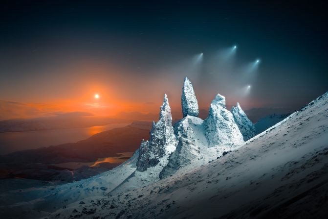 Liam Man won Open Photographer of the Year for Moonrise Sprites over Storr, depicting the Old Man of Storr rock formation on the Isle of Skye, Scotland, lit by drone lights and the rising orange moon.