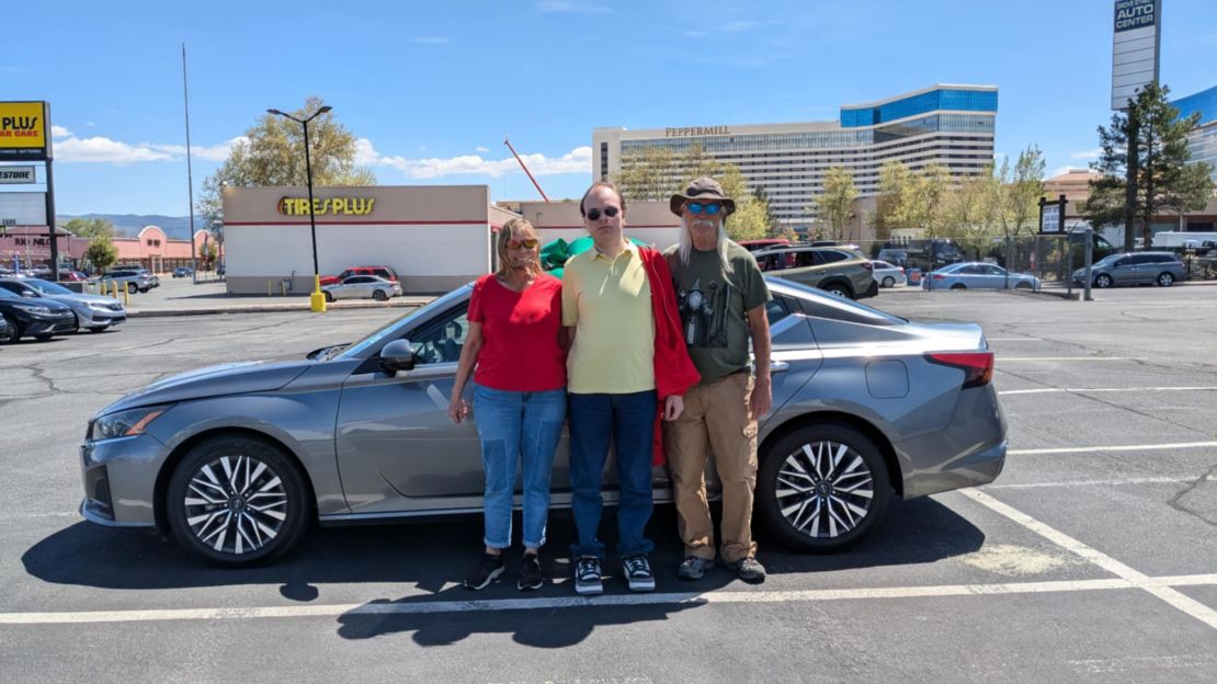 Linda Wilburn in front of her new car with her son (center) and her boyfriend (right) on April 30 in Reno, Nevada.