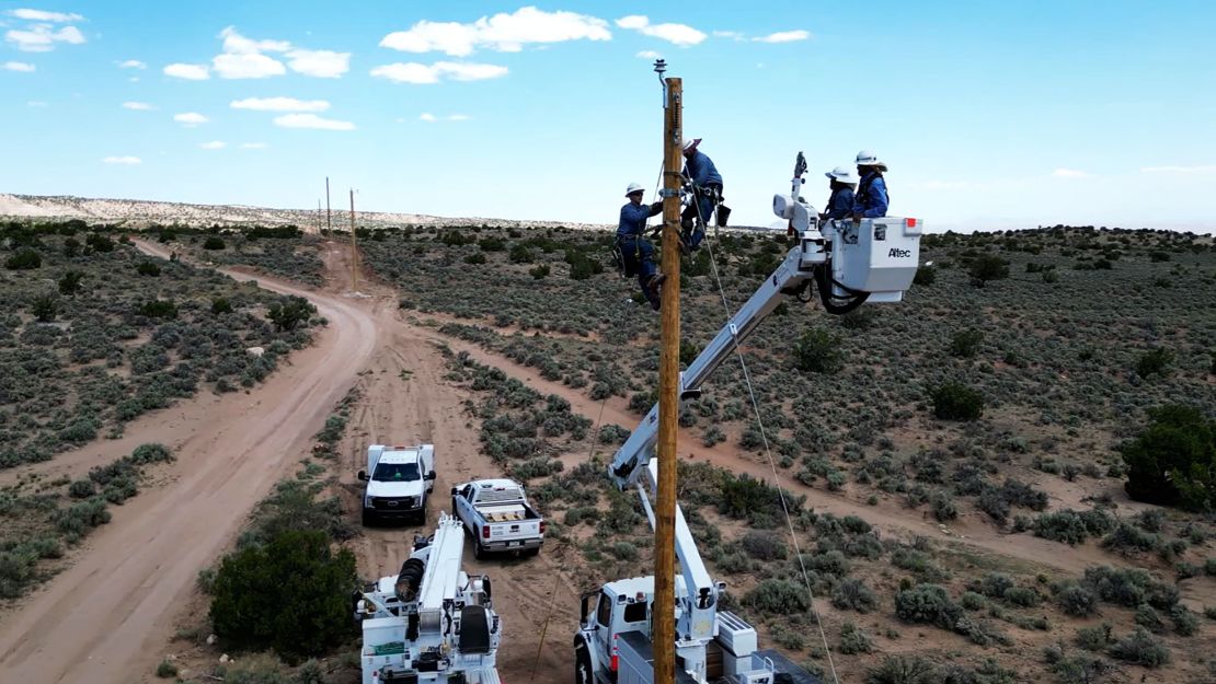 Linemen work to install power lines to bring electricity to the Navajo Nation.