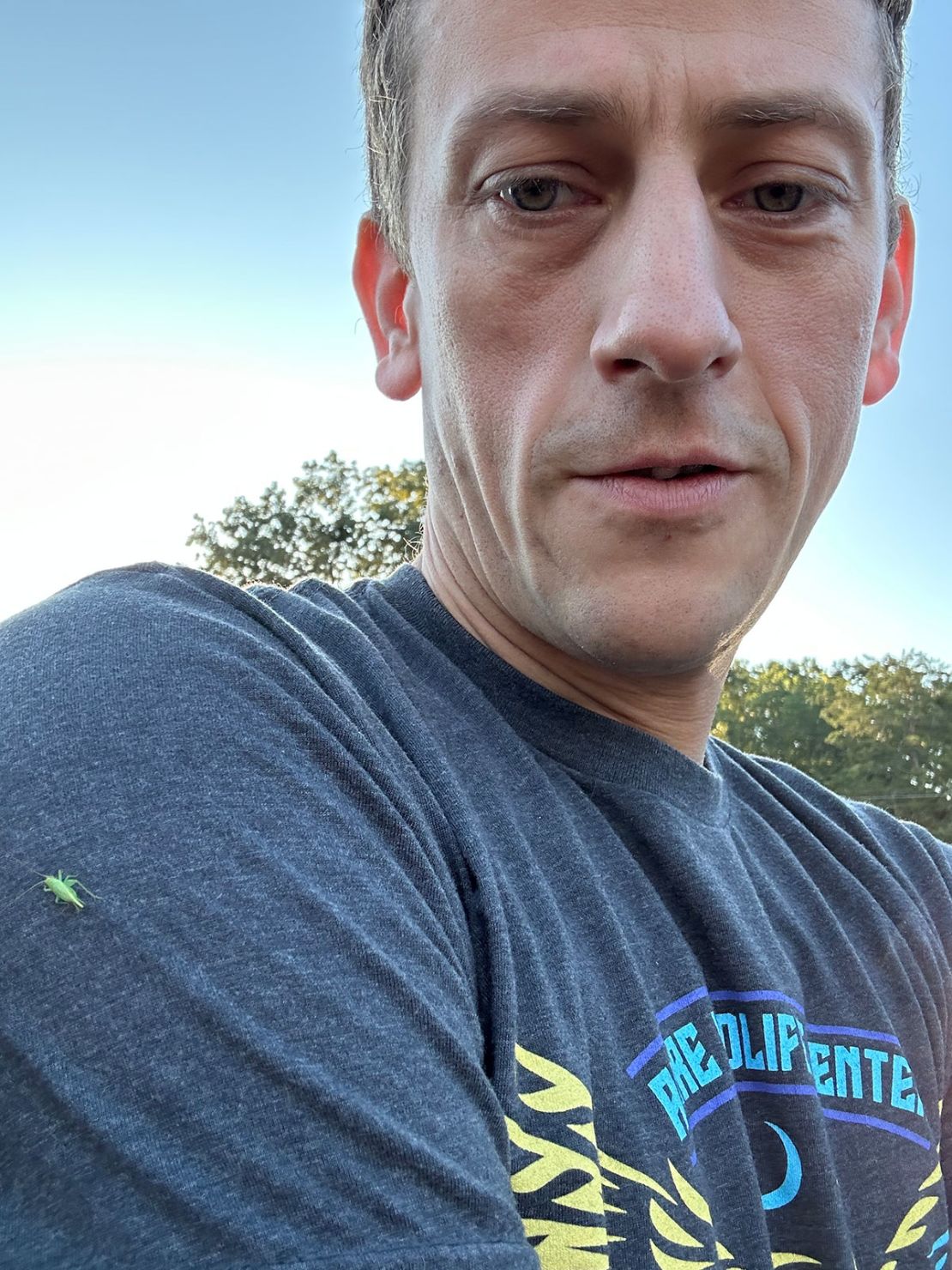 CNN senior writer Thomas Lake takes a photo with a bug on his shirt following a 5K.