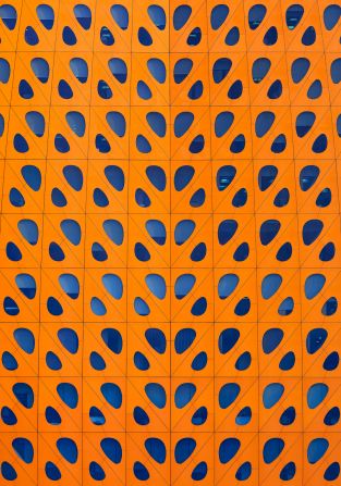 Liwa Tower, Abu Dhabi: The bright orange exterior of Liwa Tower is hard to miss. Completed in 2014, the 20-story steel structure took five years to build. The symmetrical design of abstract, imperfect ovals was <a href="https://www.instagram.com/p/BfJJAXMAc2w/?hl=en" target="_blank">one of AlMoosawi’s first images</a> in the project.