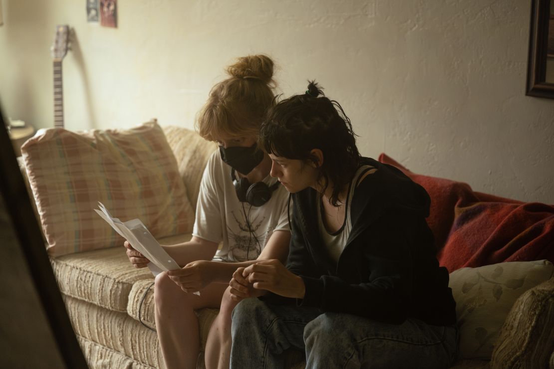Writer-director Rose Glass and actor Kristen Stewart in discussion on the set of "Love Lies Bleeding."