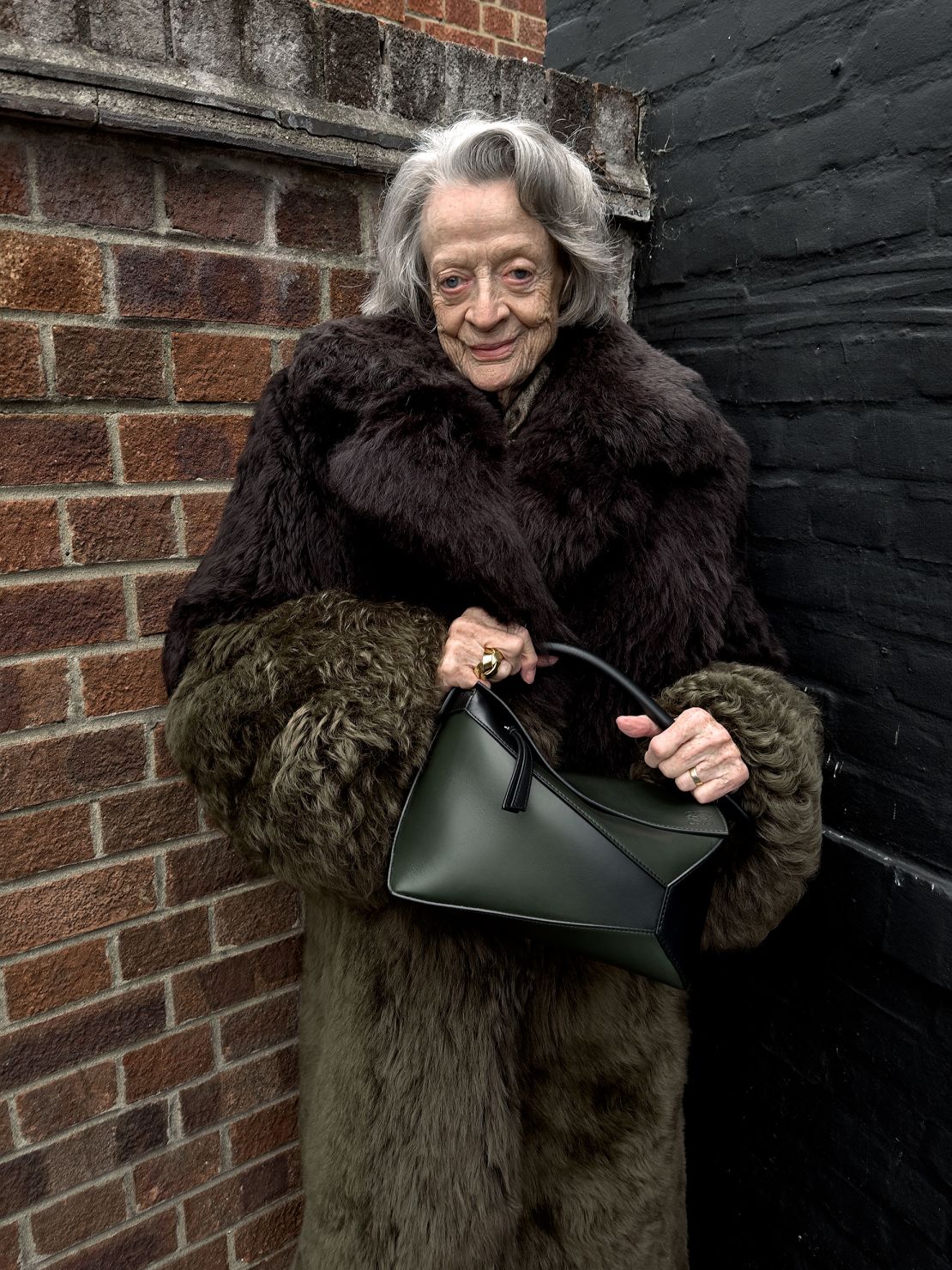 Maggie Smith, 88, wears a floor-length faux fur coat.