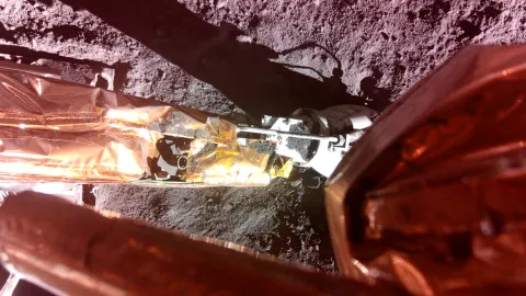 The Lunar PlanetVac instrument, developed by Honeybee Robotics, was deployed to the lunar surface and is shown at the end of Blue Ghost’s surface access arm. Credit: Firefly Aerospace