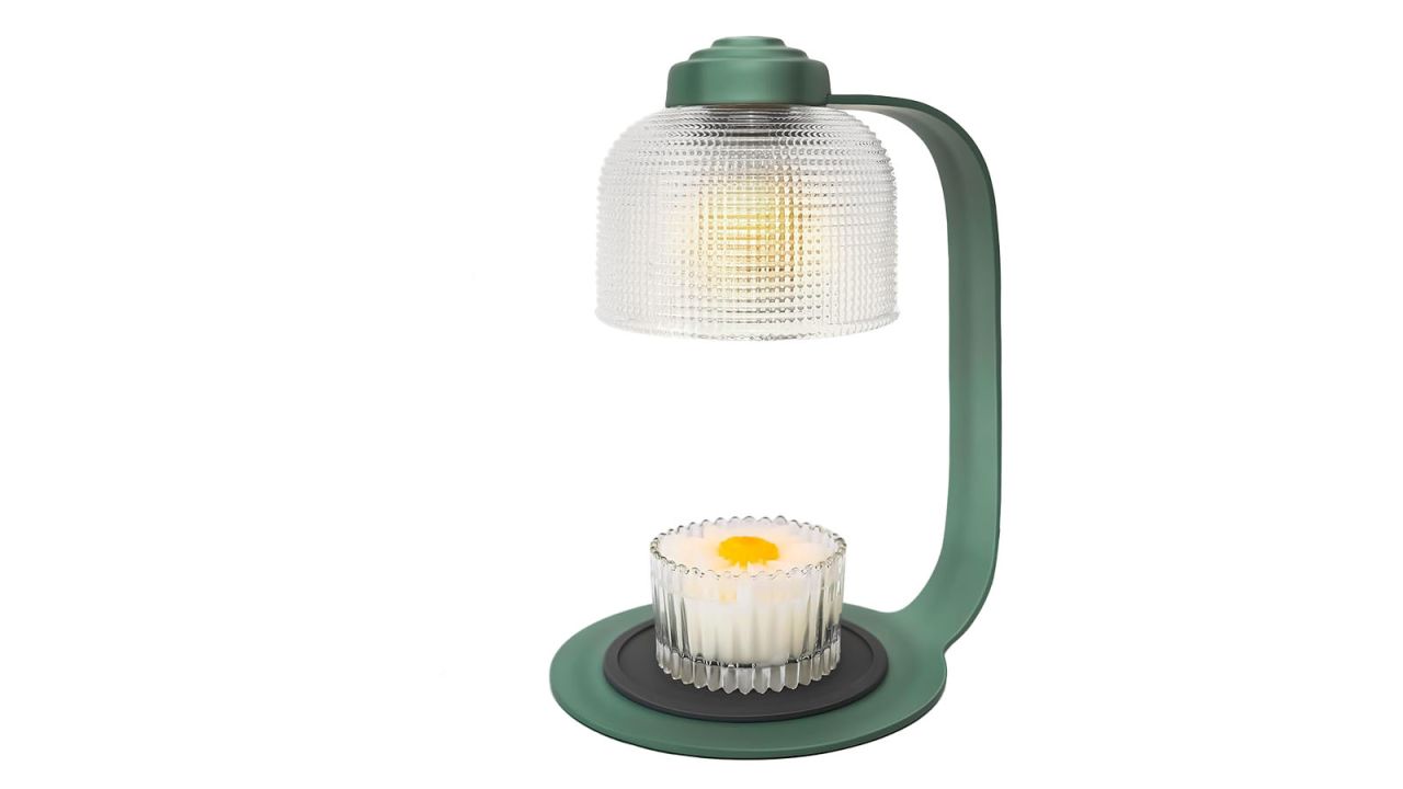 Candle warmer lamp with circular lamp shade and small candle placed at base.