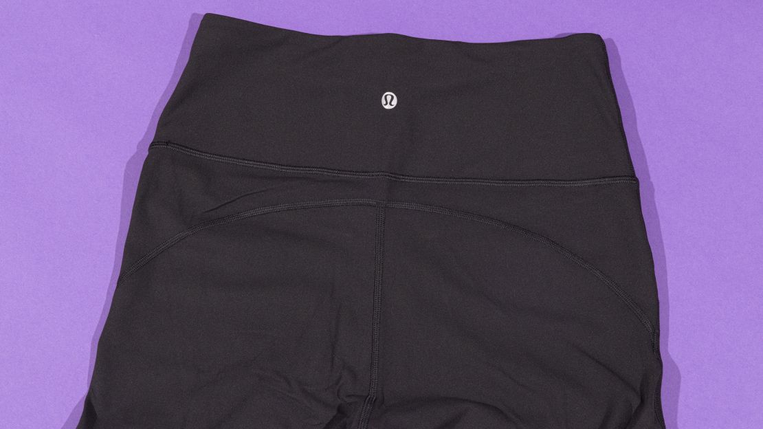 Back of Lululemon Groove leggings with purple background.