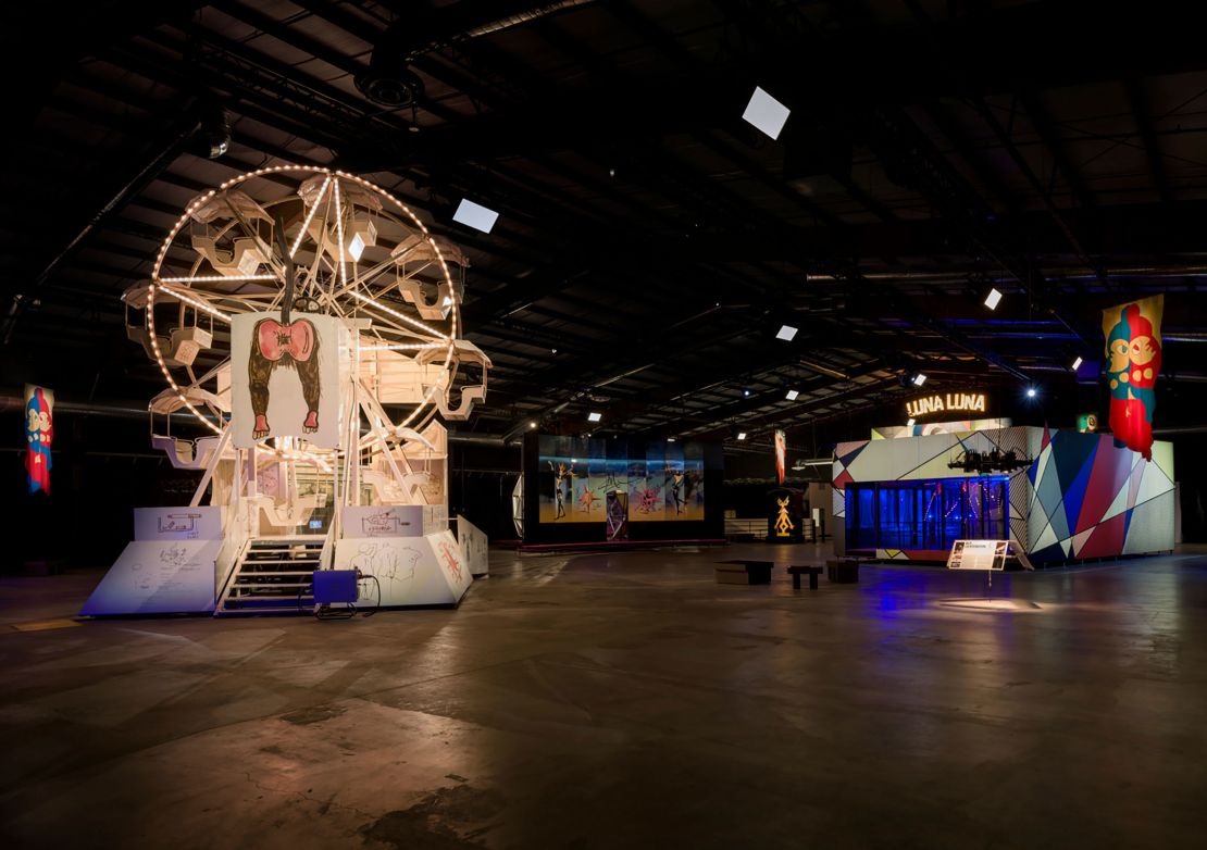 Designs and drawings by Jean-Michel Basquiat adorn a vintage Ferris wheel (left), pictured among other "Luna Luna: Forgotten Fantasy" attractions.