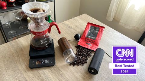 Hario V60 pour-over coffee device next to Comandante C40 MK4 and Timemore C3 manual coffee grinders.