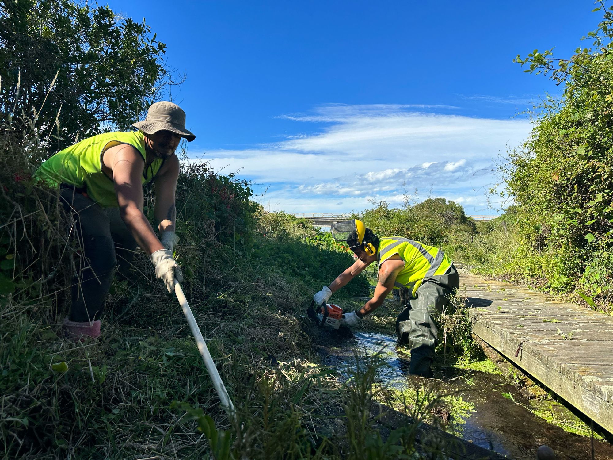 Nikora Wati, left, and Tamati Wikiriwhi clean out a river in Kaikōura, New Zealand, to help restore the region's natural ecosystem.