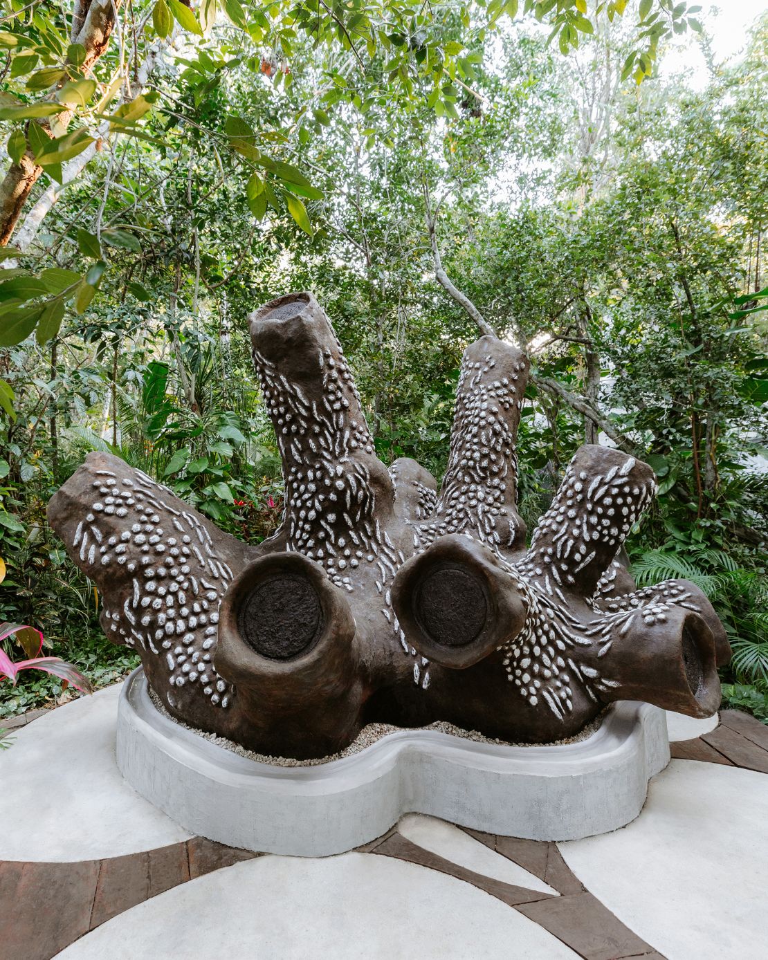 Created by Marlene Huissoud, the beehive, named “Mama,” resembles a dynamic group of tree trunks.