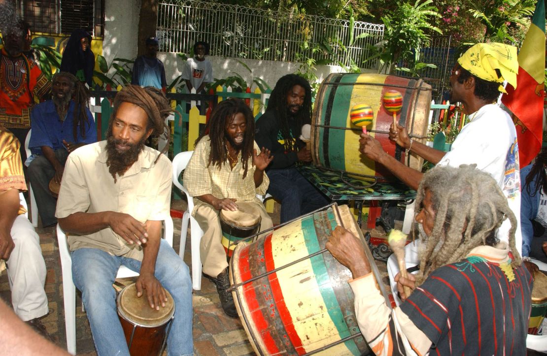 Rastafarians beat on African drums to mark the 59th birthday of late reggae legend Bob Marley on February 6, 2004, in Kingston, Jamaica. (AP Photo/Collin Reid)