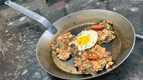 The Matfer Bourgeat 11 7/8” Black Carbon Steel Fry Pan, with breakfast preparation.