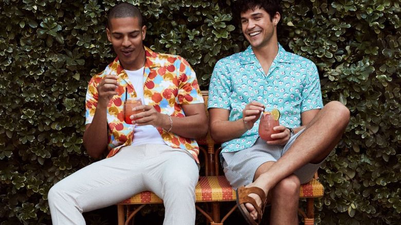 Two men sitting on a bench outdoors