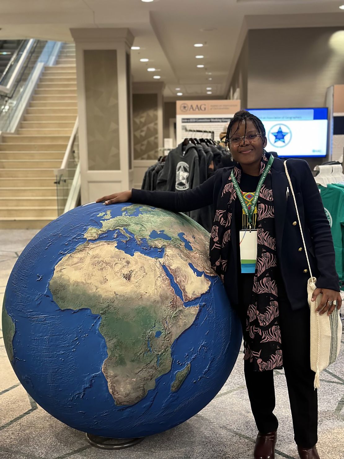 University of Florida doctoral student Metolo Foyet, pictured here at an American Association of Geographers conference in Denver, says international students like her are waiting to see whether Trump's campaign promise will become a reality.