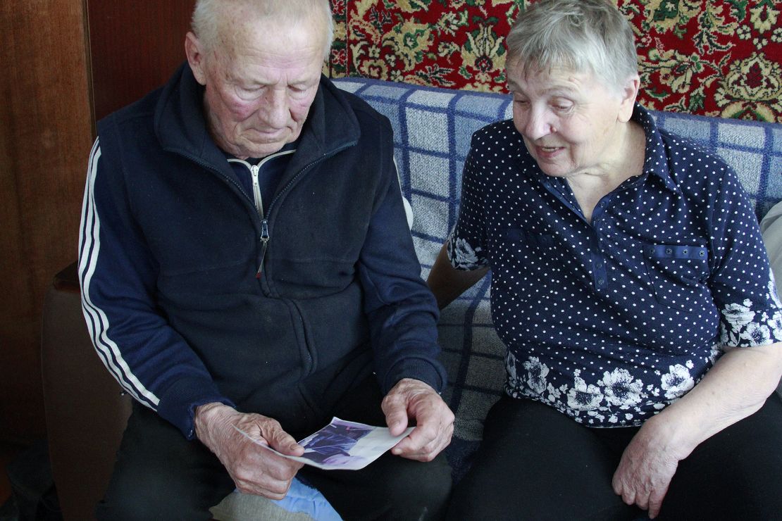 Halyna and Vasyl Khyliuk look at a picture of their son in their home in Kozarovychi, Ukraine.