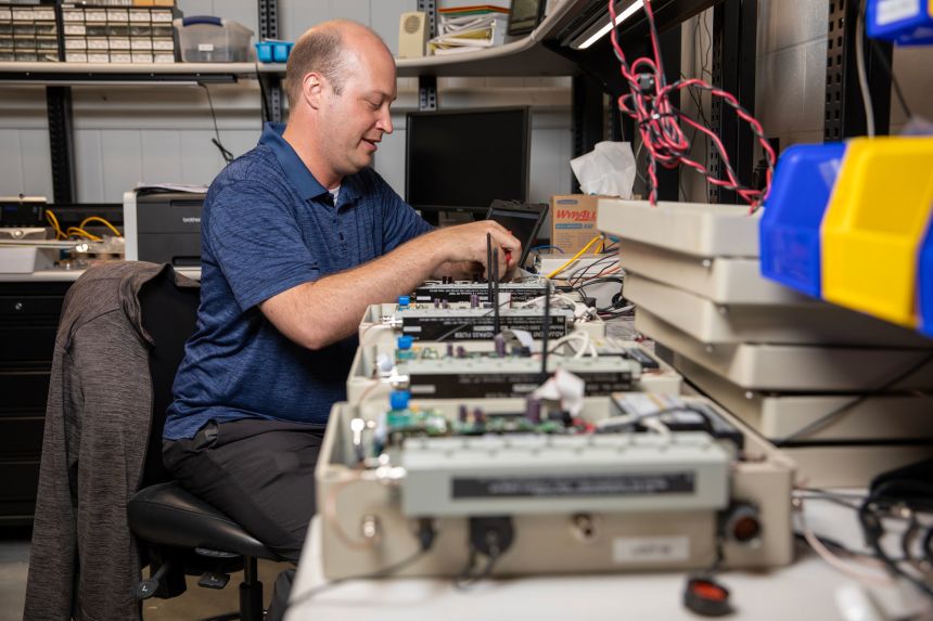 Michael Peterson, a meteorologist and senior research scientist, works on a lightning mapping array device in GTRI’s Severe Storms Research Center.