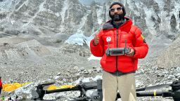 Drone pilot Milan Pandey stands at Everest Base Camp.