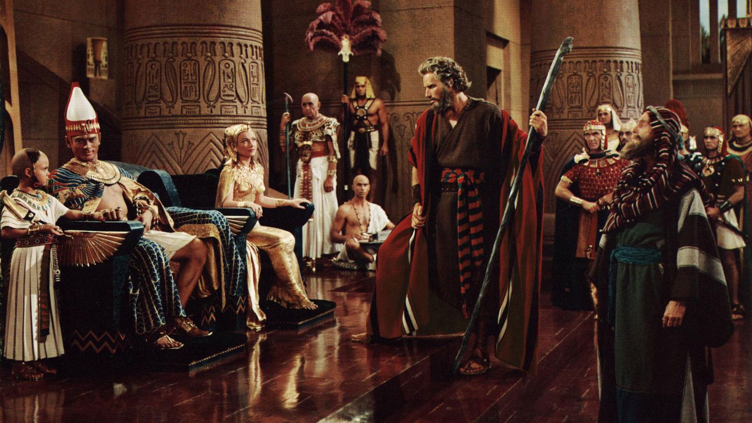 Yul Brynner and Anne Baxter (seated, left) as Rameses and Nefretiri and Charlton Heston (center) as Moses in the 1956 film "The Ten Commandments."