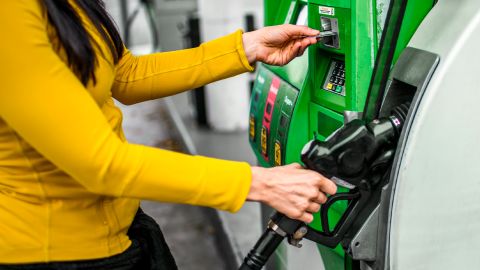 best gas credit card woman hand at pump