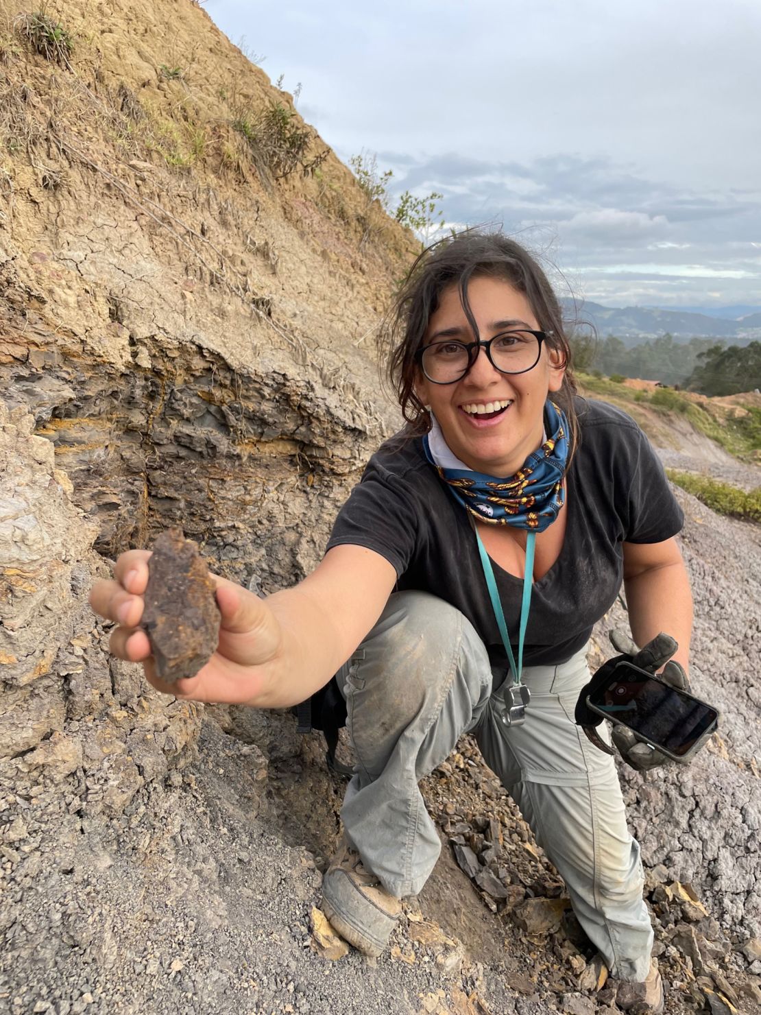 Mónica Carvalho can be seen holding the newly discovered earliest grape from the Western Hemisphere at the dig site in Colombia.