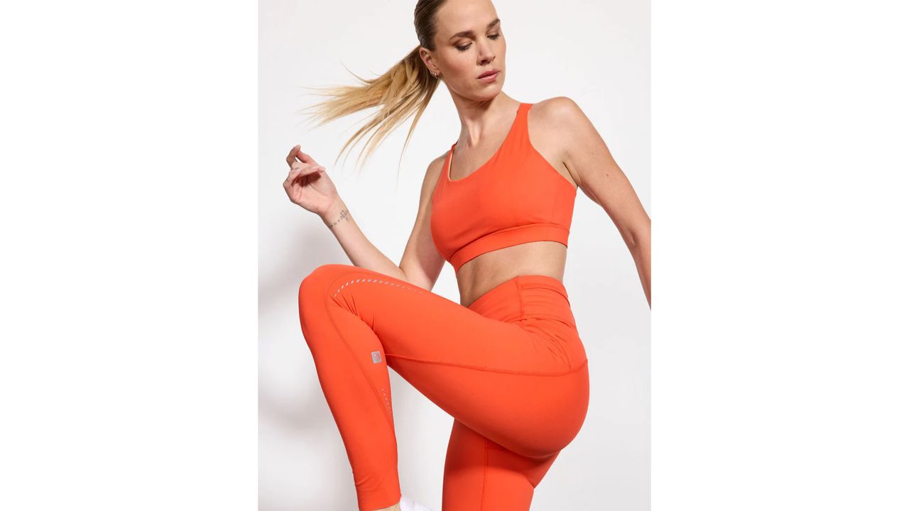 Woman wearing orange MPG Sport vital running tights
