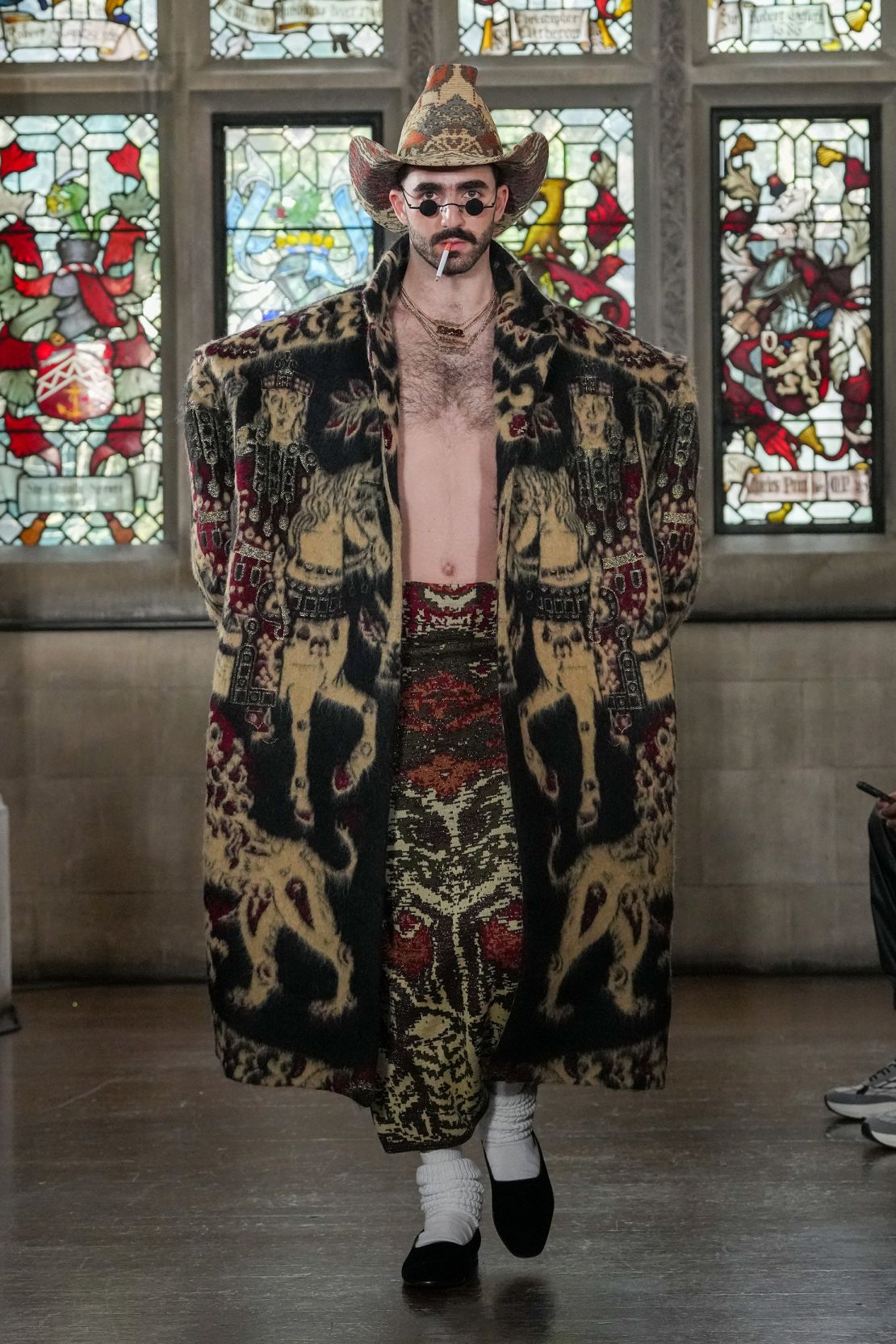 Edward Crutchley was inspired by cultures across the world, and repurposed woven tapestries into skirts, jackets and cowboy hats.