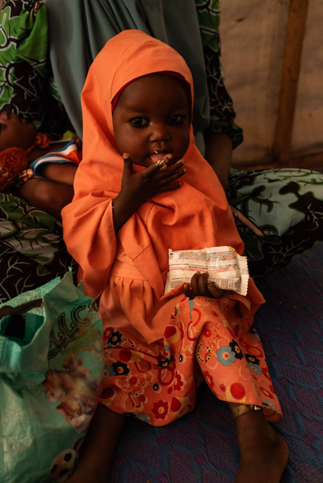 A girl in Nigeria's Katsina state eats Ready To Use Therapeutic Food (RUTF), a specially fortified peanut butter paste that can save the lives of malnourished children.